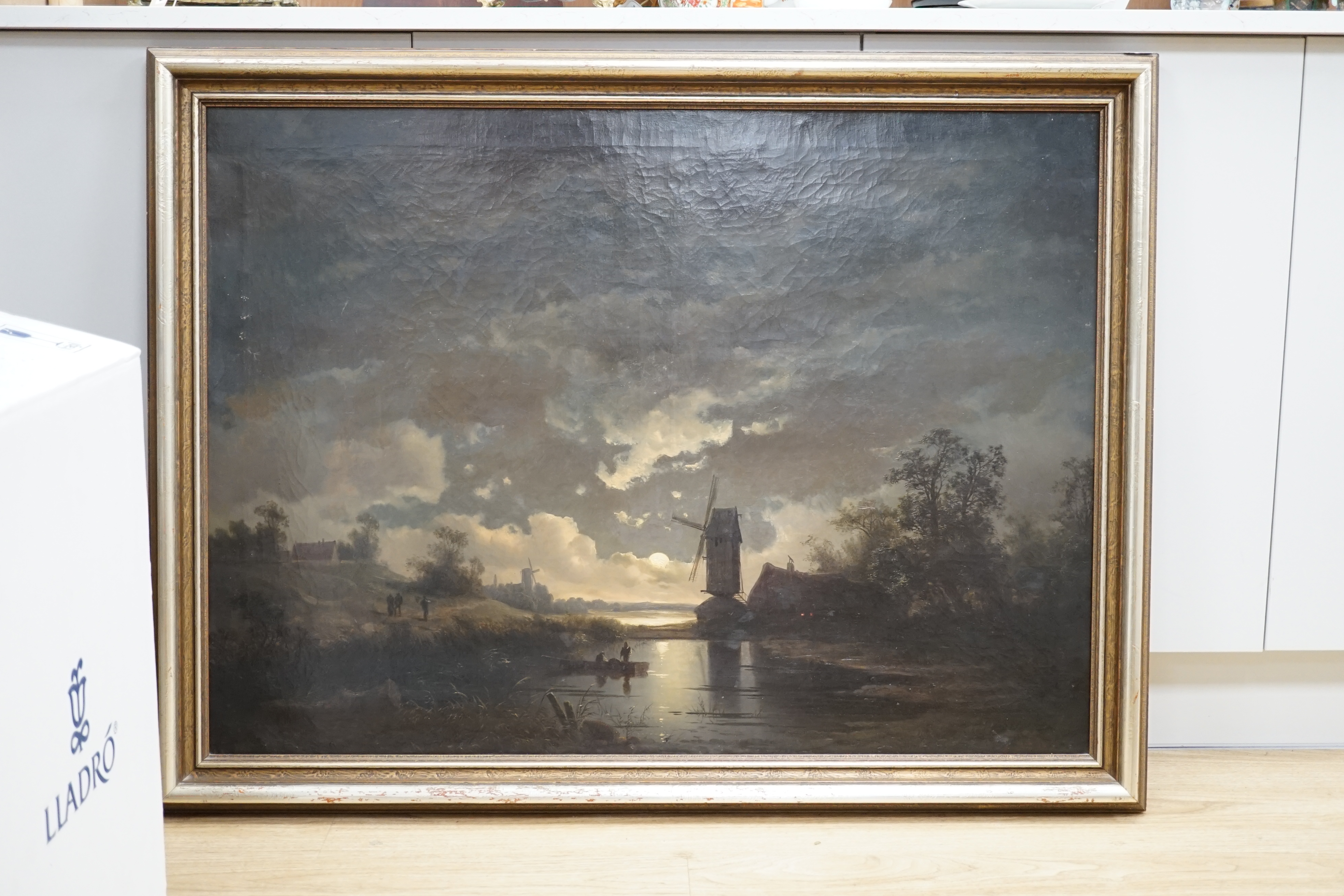 German School, oil on canvas, moonlit river landscape with windmill, indistinctly signed, 98cm x 71cm